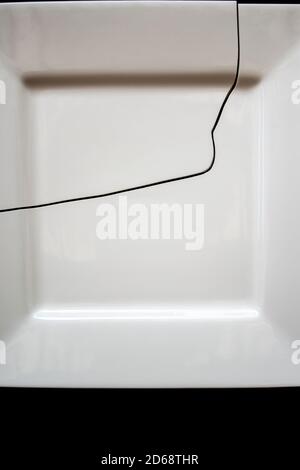 Still life of a cracked white dinner plate Stock Photo
