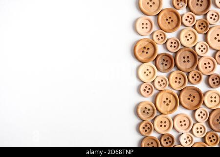 various wooden beige buttons on a white background, top view flat lay Stock Photo