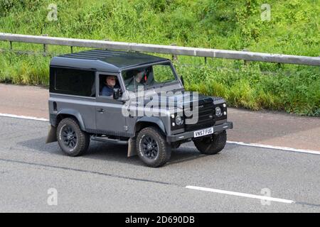 2007 Image 4x4 modified black grey off-roader Land Rover Defender 90 Hard Top; Vehicular traffic moving vehicles, off road driving vehicle on UK roads, motors, car customization, motoring on the M6 motorway highway Stock Photo