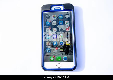 An Apple iPhone Plus in a rubberised case with a screen full of icons for different apps. Stock Photo