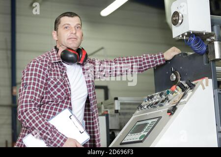 factory engineer operating hydraulic tube bender Stock Photo