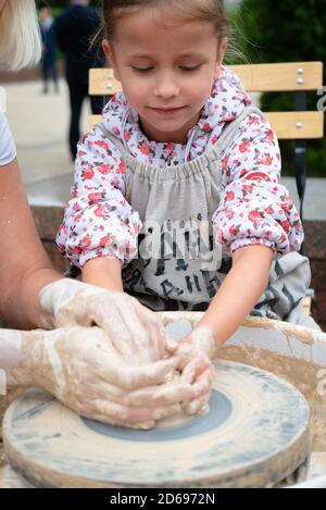 Ryazan, Russia - July 27, 2019: Kid during pottery master-class on street festival Stock Photo