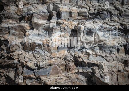 Background of limestone masonry. The surface is decorated with natural material. The wall is made of wild stone. High quality photo Stock Photo