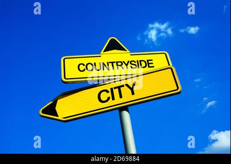 Countryside or City - Traffic sign with two options - settle in village near by nature vs live in lively and busy city. Urbanization and moving of inh Stock Photo