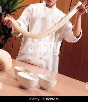 Chinese chef making fresh noodles Stock Photo