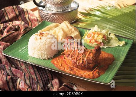 Indian cuisine chicken curry with achaar, rice and papadum Stock Photo