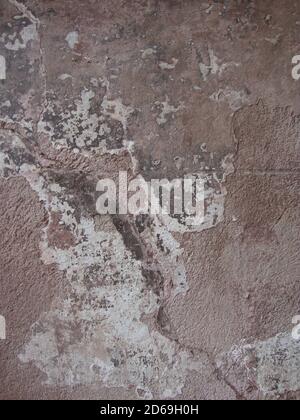Vertical closeup shot of cracks on a concrete wall as a background Stock Photo