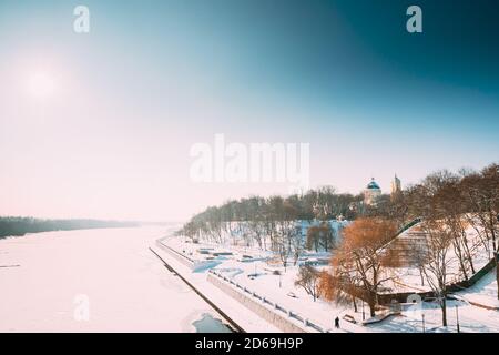 Gomel, Belarus. Winter City Park, Frozen River, Embankment And Peter And Paul Cathedral In Sunny Winter Day. Famous Local Landmark In Snow Stock Photo