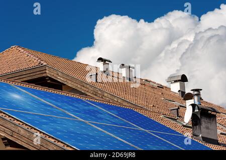 Close-up of a house roof with a solar panels on the top. Renewable Energy concept Stock Photo