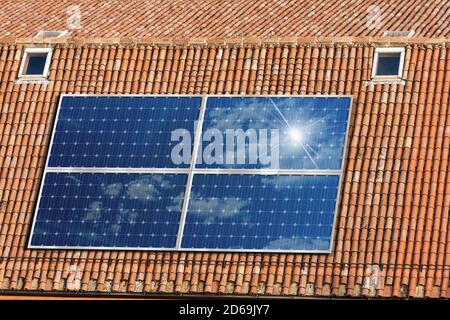 Close-up of a house roof with a solar panels on the top, view from above. Renewable Energy concept Stock Photo