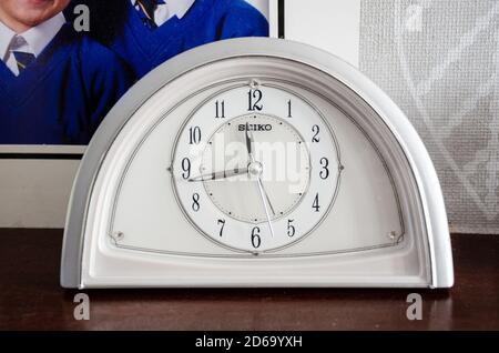 Close up view of an analogue clock on a mantelpiece in a family home. Stock Photo