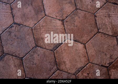 Vintage brown ceramic tile in the form of honeycombs. Hexagonal floor tiles. Stock Photo
