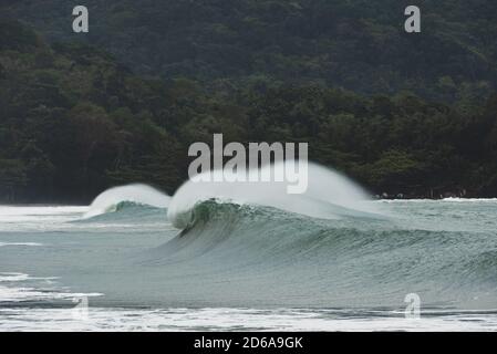 A wave breaks at Castelhanos, Ilhabela, Brazil Stock Photo
