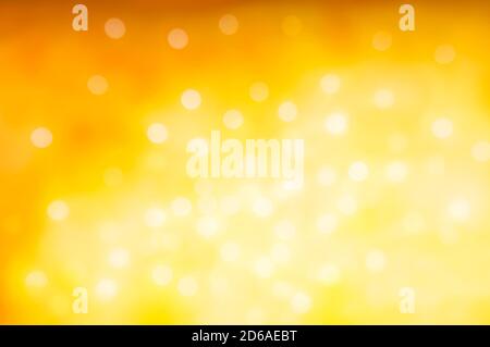 Christmas and New Year holidays blurred orange sparkles background, abstract background with bokeh defocused glittering lights and shadow. Stock Photo