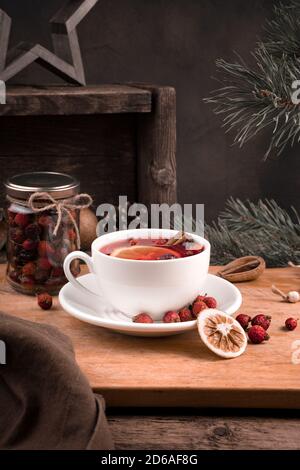 White tea Cup with lemon and berries on Christmas background. Stock Photo