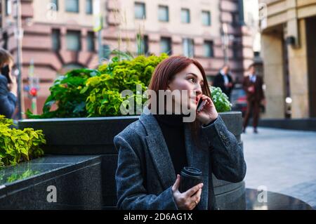 Business woman talking on a phone in a city downtown. Female outdoor portrait. Stock Photo