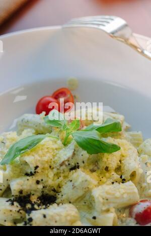 Italian food - rigatoni pasta with basil and black truffle Stock Photo