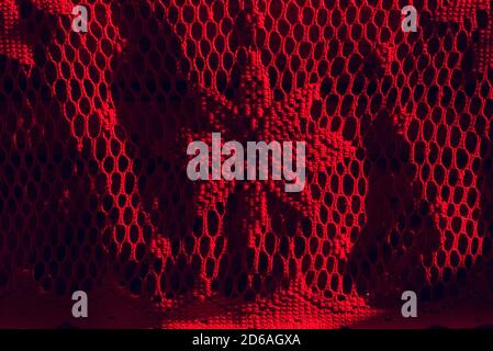 Red knitted fabric. Red fabric mesh in a flower Stock Photo