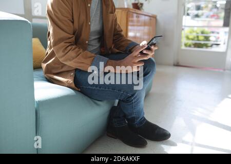 Mid section of man using smartphone Stock Photo