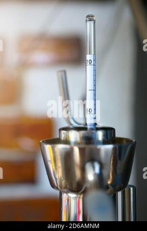 homemade moonshine winemaking; Alcoholmeter in Hydrometer Jar, test barrel for home brandy production Stock Photo