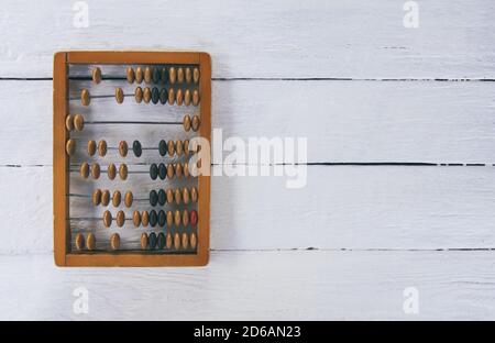 Vintage wooden abacus on white board surface. Stock Photo
