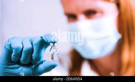 COVID-19 Coronavirus Vaccine. Female Doctor scientist analyzing and researching in laboratory. Stock Photo