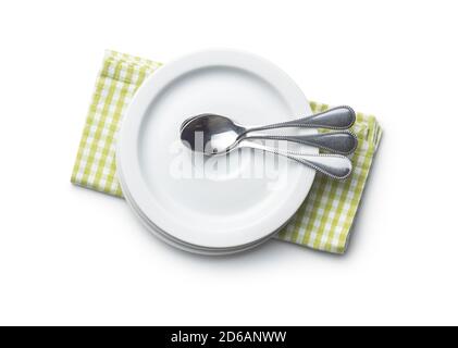 Dessert plates and spoons on checkered napkin isolated on white background. Stock Photo