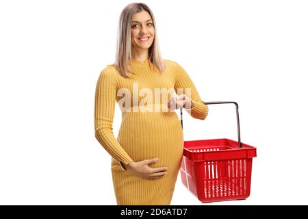 Full length shot of a happy pregnant woman holding an empty shopping basket isolated on white background Stock Photo