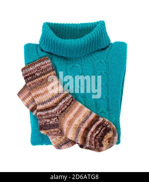 Blue warm knitted sweater with a pattern and socks. Isolate on white. Warm winter clothes. Stock Photo
