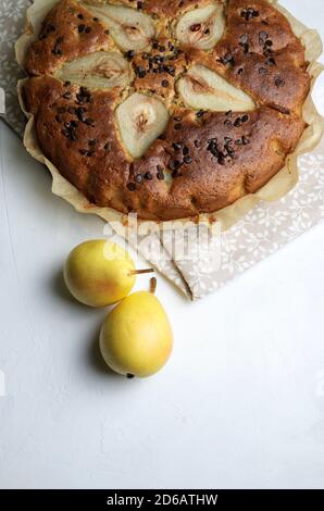 Pear and chocolate chip cake on white background. Top view.