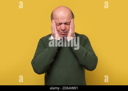 Senior caucasian man having terrible headache. Stress concept. Stock Photo