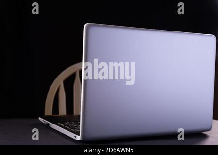 Modern laptop on table on black background Stock Photo