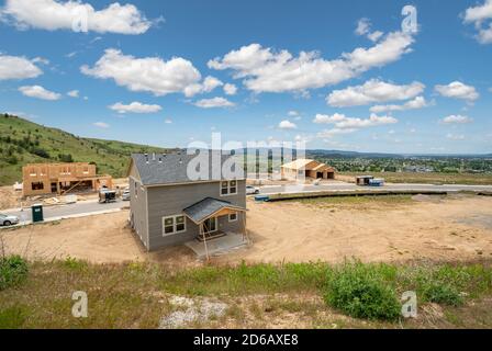 New construction homes being built in a subdivision hilltop overlooking a valley in an area of new homes in the Spokane, Washington area of the USA Stock Photo