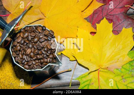 Coffee in a moka pot with coffee beans and ground coffee on blur dark background. Stock Photo