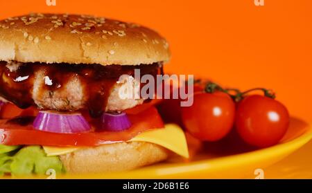 Hamburger or sandwich. Delicious sandwich hamburger with meat, cheese and fresh vegetable. Hamburger or sandwich is the popular fast food for brunch Stock Photo