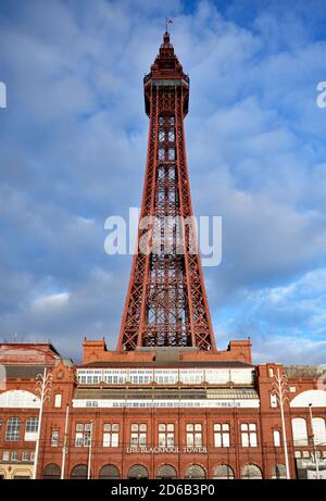 The Victorian Blackpool Tower and tower complex building as the setting sun shines on to the orange and red colours.  Lancashire, England.