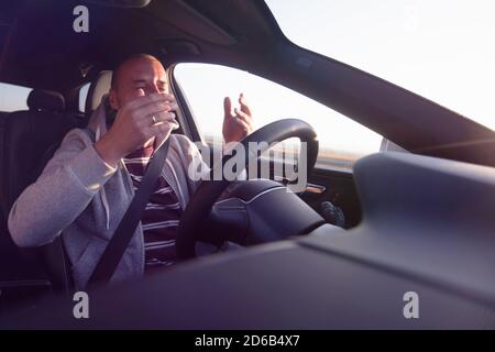 Young man driving a car shocked about to have traffic accident. Stock Photo