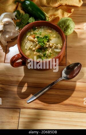 Ground pork green chili con carne with tomatillo and navy beans Stock Photo