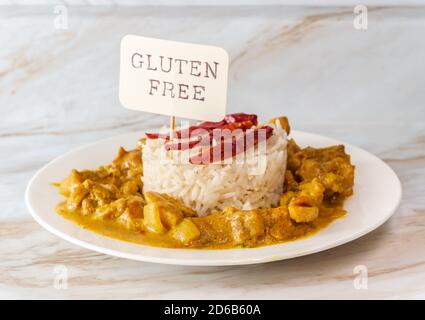 Authentic spicy Indian chicken korma curry with jasmine rice gluten free Stock Photo