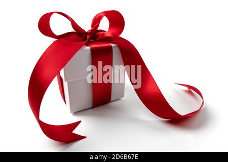 White gift box with red ribbon bow, isolated on white Stock Photo