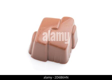 Single chocolate candy isolated on white background. side view, close up. Stock Photo