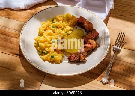 Steak and potatoes with macaroni and cheese with green peas Stock Photo