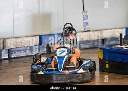 Mackay, Queensland, Australia - January 2020: A man drives a go-kart in a fun recreational drive around a circuit in public Stock Photo
