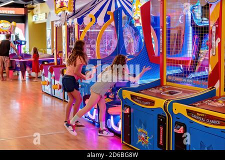 Mackay, Queensland Australia - February 2020: Two young girls playing a game in an amusement arcade Stock Photo