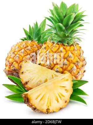 Pineapples with leaves and pineapple slices isolated on a white background. Clipping path. Stock Photo