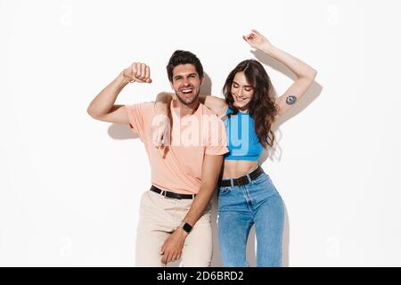 Image of attractive happy couple smiling and dancing on camera isolated over white background Stock Photo
