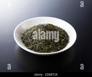 Shooting tea leaves placed on a black background from an angle Stock Photo