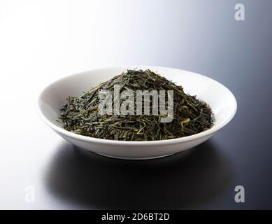 Shooting tea leaves placed on a black background from an angle Stock Photo