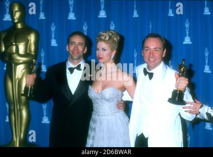 Los Angeles, California, USA 25th March 1996 (L-R) Best Actor Winner Nicolas Cage ('Leaving Las Vegas'), Best Supporting Actress Winner Mira Sorvino ('Mighty Aphrodite'), Best Supporting Actor Winner Kevin Spacey ('The Usual Suspects') pose with their Oscars in press room at the 68th Annual Academy Awards at Dorothy Chandler Pavilioin on March 25, 1996 in Los Angeles, California, USA. Photo by Barry King/Alamy Stock Photo Stock Photo