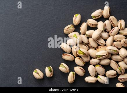A bird's-eye view of pistachios on a black background Stock Photo